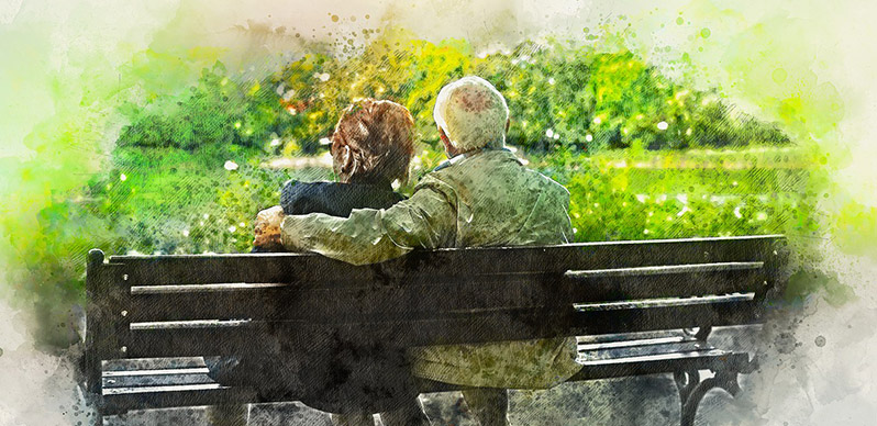 Äldre par sitter på en bänk